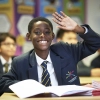 A student raising their hand in class