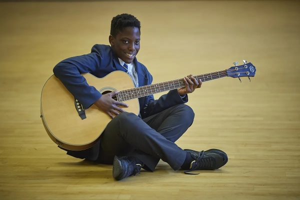 A student playing the guitar