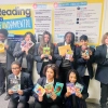 TEMA students holding their reading books